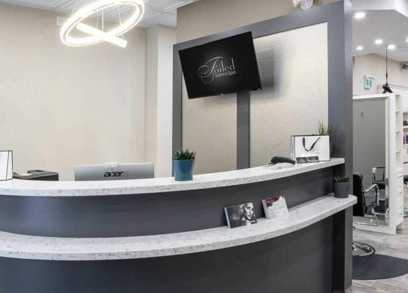 Reception area at Foiled Salon and Spa, Cambridge, Ontario, CA with chic decor and modern furnishings.