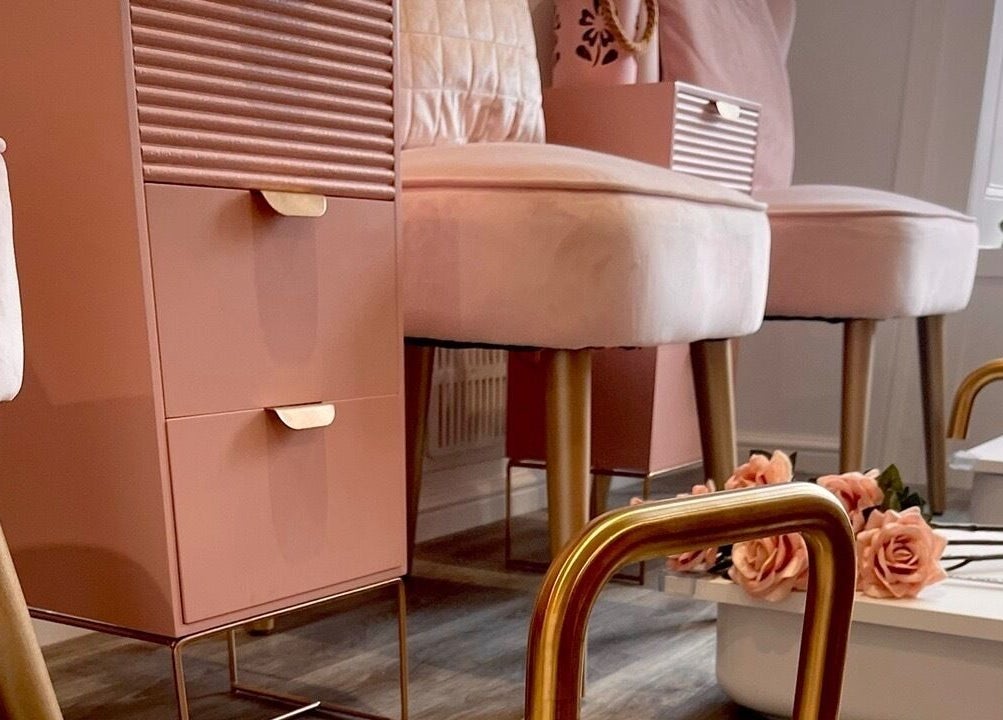 Chic pedicure station at Totally Polished Tadcaster in Tadcaster, England, GB with soft pink seating and decor.