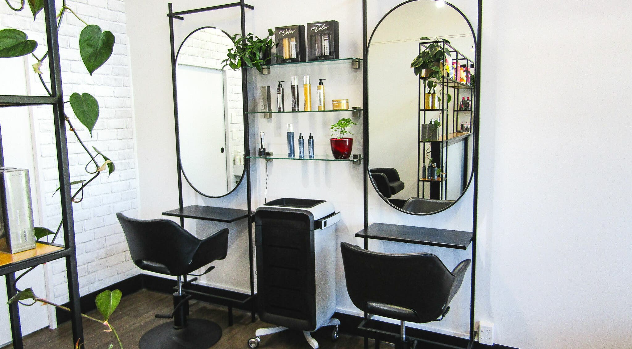 Modern salon chairs and mirrors at The Hair Shop Limited, Auckland, NZ, showcasing stylish interior design.