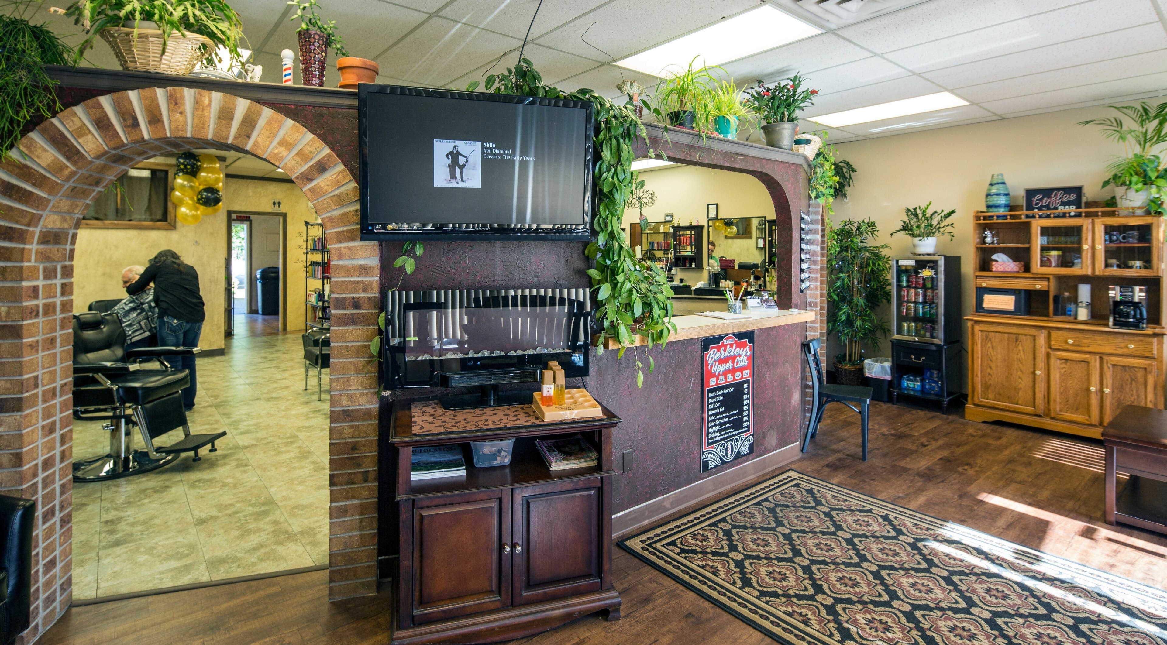 Relaxing interior of Berkleys Upper Cuts in Grand Junction, Colorado, US. Features salon chairs and stylish decor.