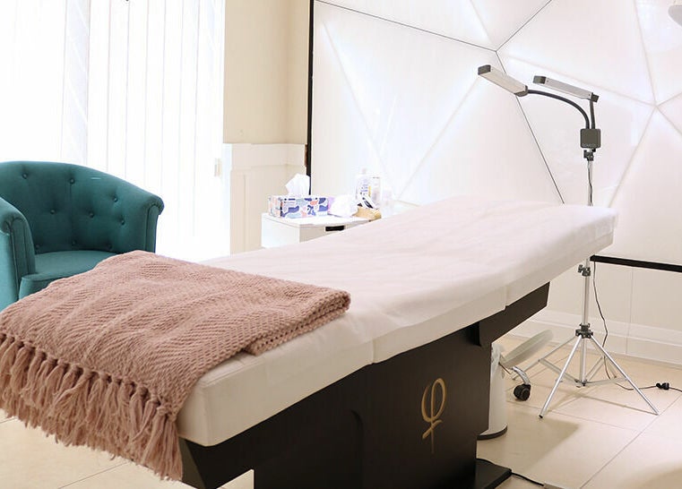 Luxurious treatment room at Phi Studio Dubai, Dubai, AE, highlighting a cozy chair and massage table.