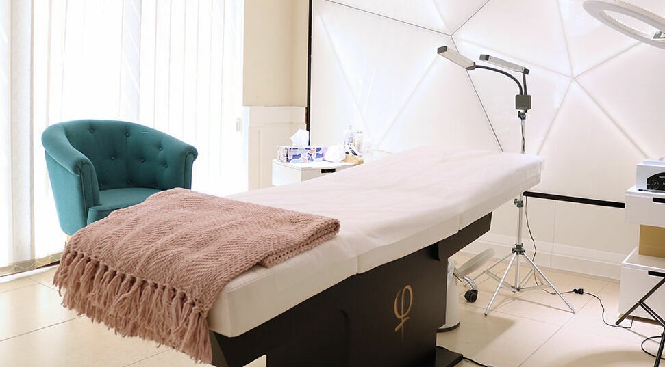 Luxurious treatment room at Phi Studio Dubai, Dubai, AE, highlighting a cozy chair and massage table.