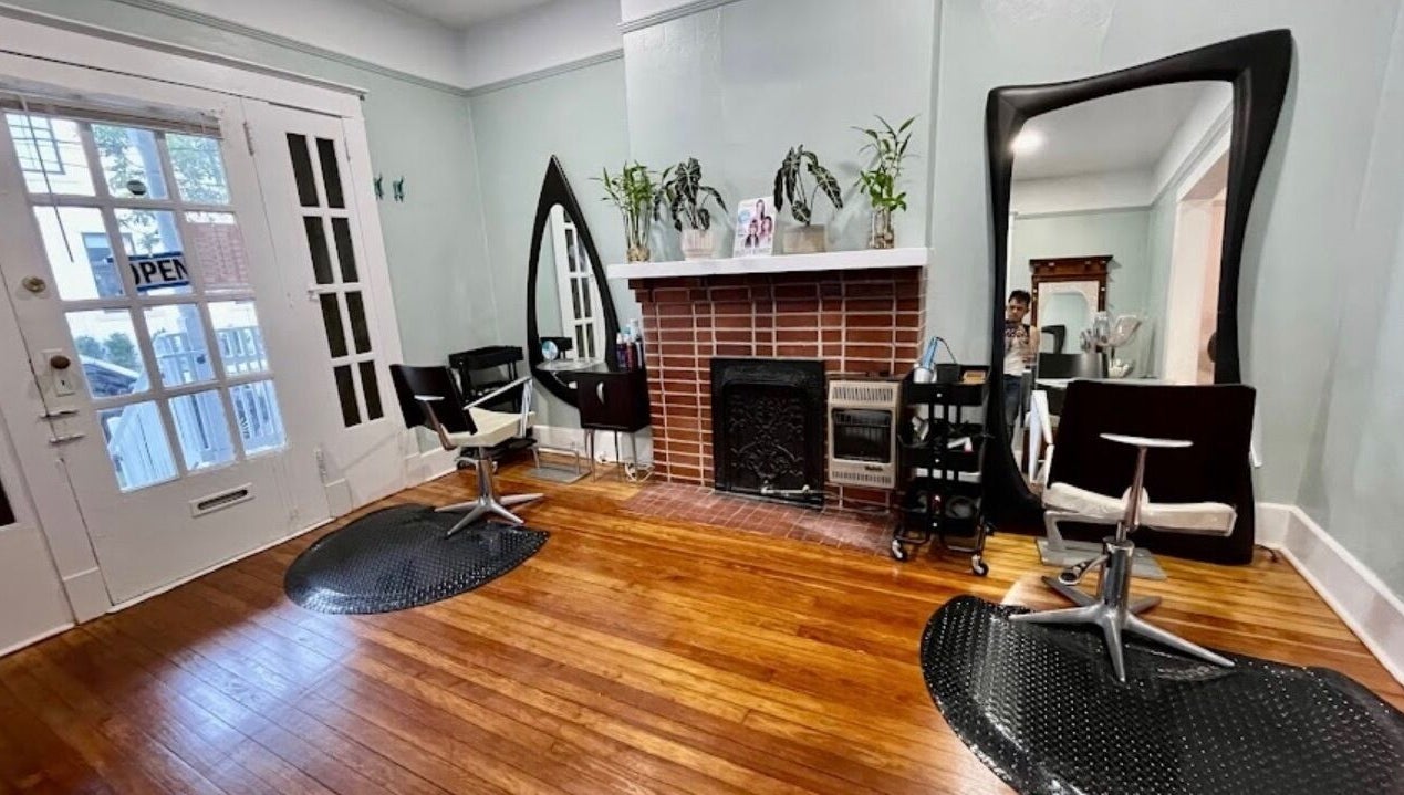 Elegant salon space at The Xperience Cut in New Orleans, Louisiana, US with mirrors and styling chairs.