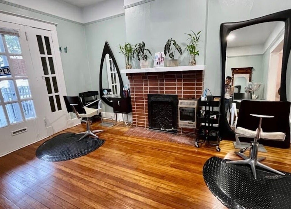 Elegant salon space at The Xperience Cut in New Orleans, Louisiana, US with mirrors and styling chairs.
