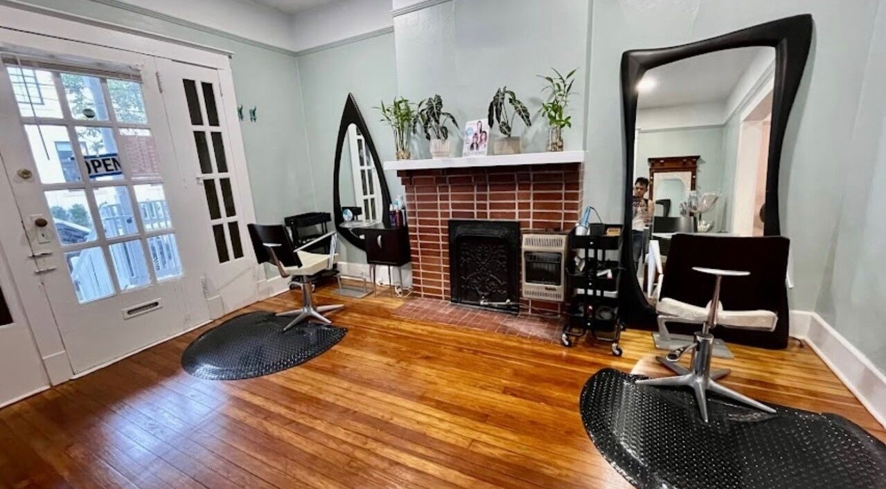 Elegant salon space at The Xperience Cut in New Orleans, Louisiana, US with mirrors and styling chairs.