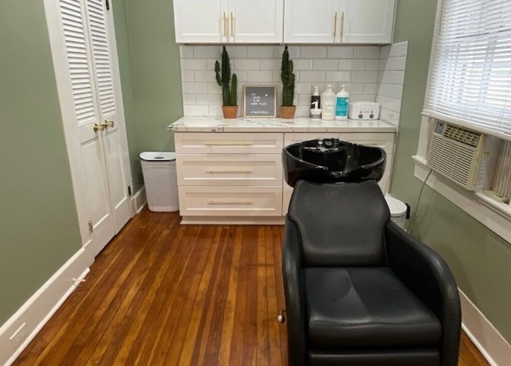 Elegant salon interior with sleek black chair at The Xperience Cut, New Orleans, Louisiana, US.