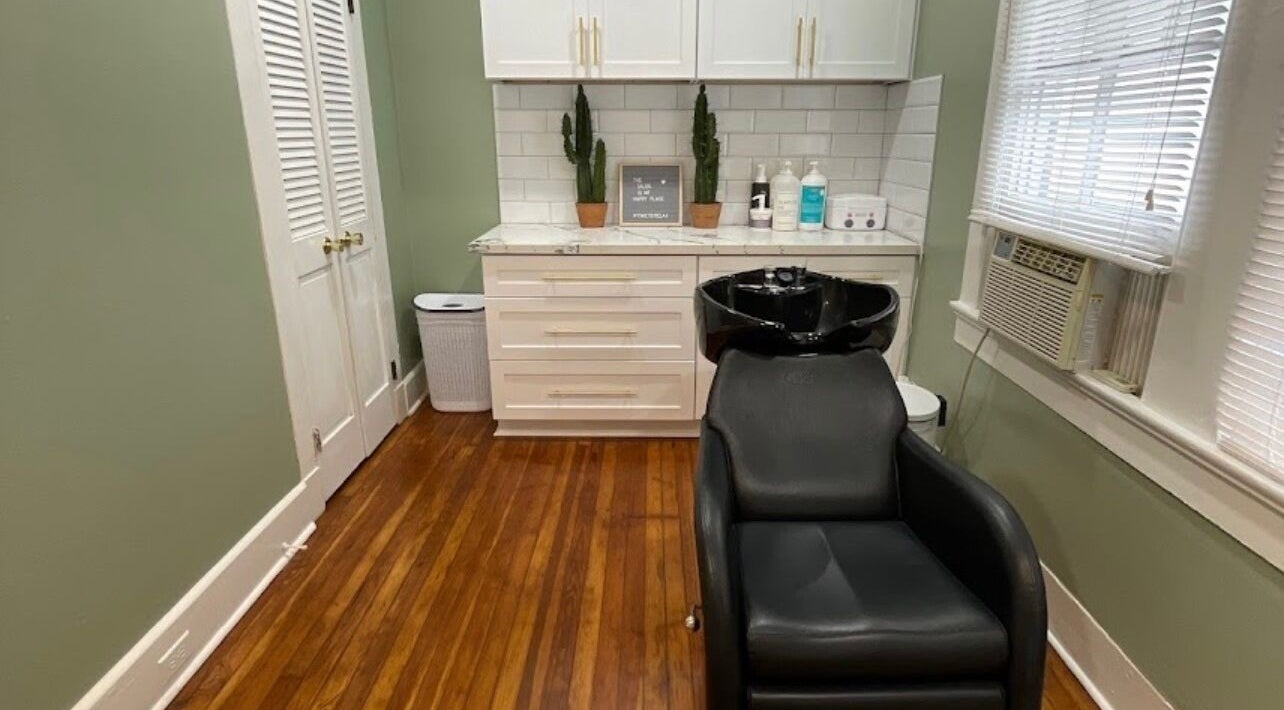 Elegant salon interior with sleek black chair at The Xperience Cut, New Orleans, Louisiana, US.