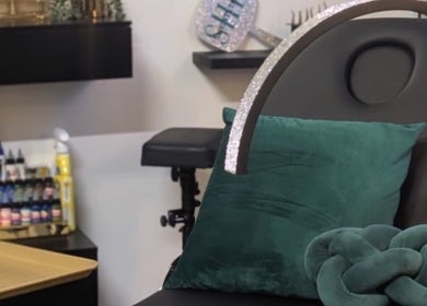 Cozy seating area at She Studios, London, Ontario, CA, featuring a stylish chair and cushion.