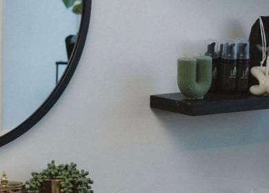 Stylish shelf and mirror at She Studios, London, Ontario, CA featuring elegant beauty products and decor.