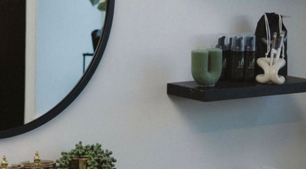 Stylish shelf and mirror at She Studios, London, Ontario, CA featuring elegant beauty products and decor.