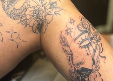 Detailed tattoo art on arm at She Studios, London, Ontario, CA, showcasing floral and celestial designs.