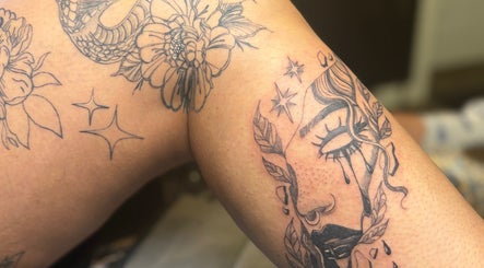 Detailed tattoo art on arm at She Studios, London, Ontario, CA, showcasing floral and celestial designs.