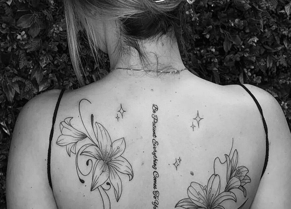 Intricate floral back tattoo at She Studios, London, Ontario, CA, showcasing delicate artistry and personal expression.