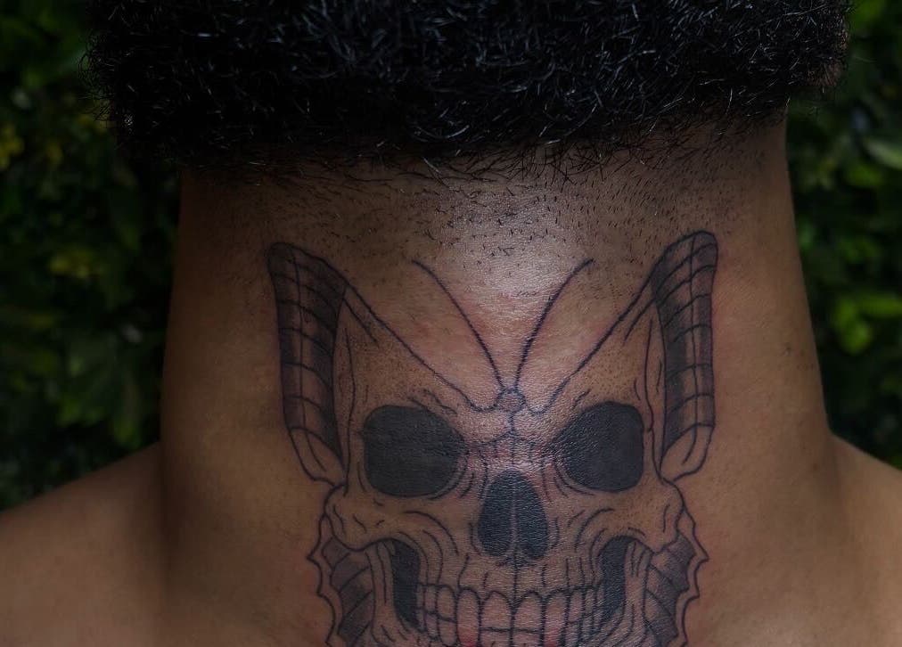 Intricate skull tattoo design on neck at She Studios, London, Ontario, CA.