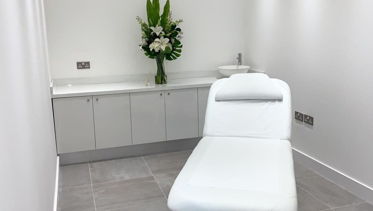 Elegant treatment room at Bespoke Brows & Aesthetics, Shirley, England, GB with a spa bed and floral decor.
