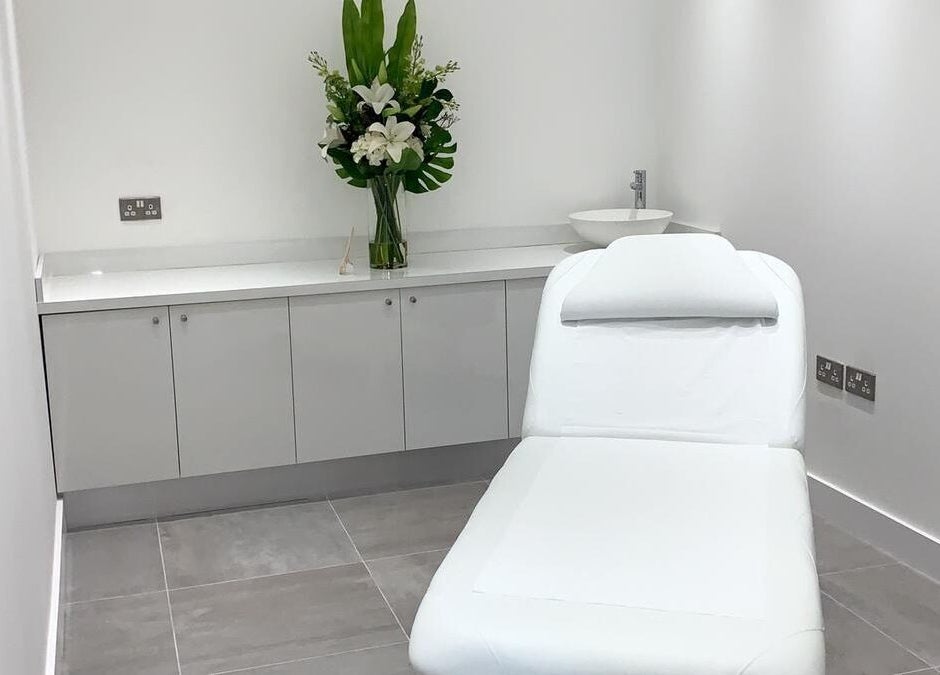 Elegant treatment room at Bespoke Brows & Aesthetics, Shirley, England, GB with a spa bed and floral decor.