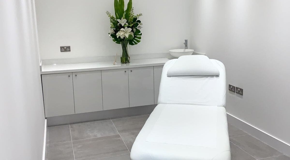 Elegant treatment room at Bespoke Brows & Aesthetics, Shirley, England, GB with a spa bed and floral decor.