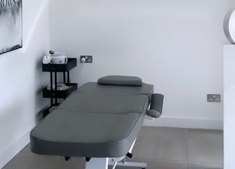 Modern treatment room at Bespoke Brows & Aesthetics, Shirley, England, GB, with a comfortable massage table.