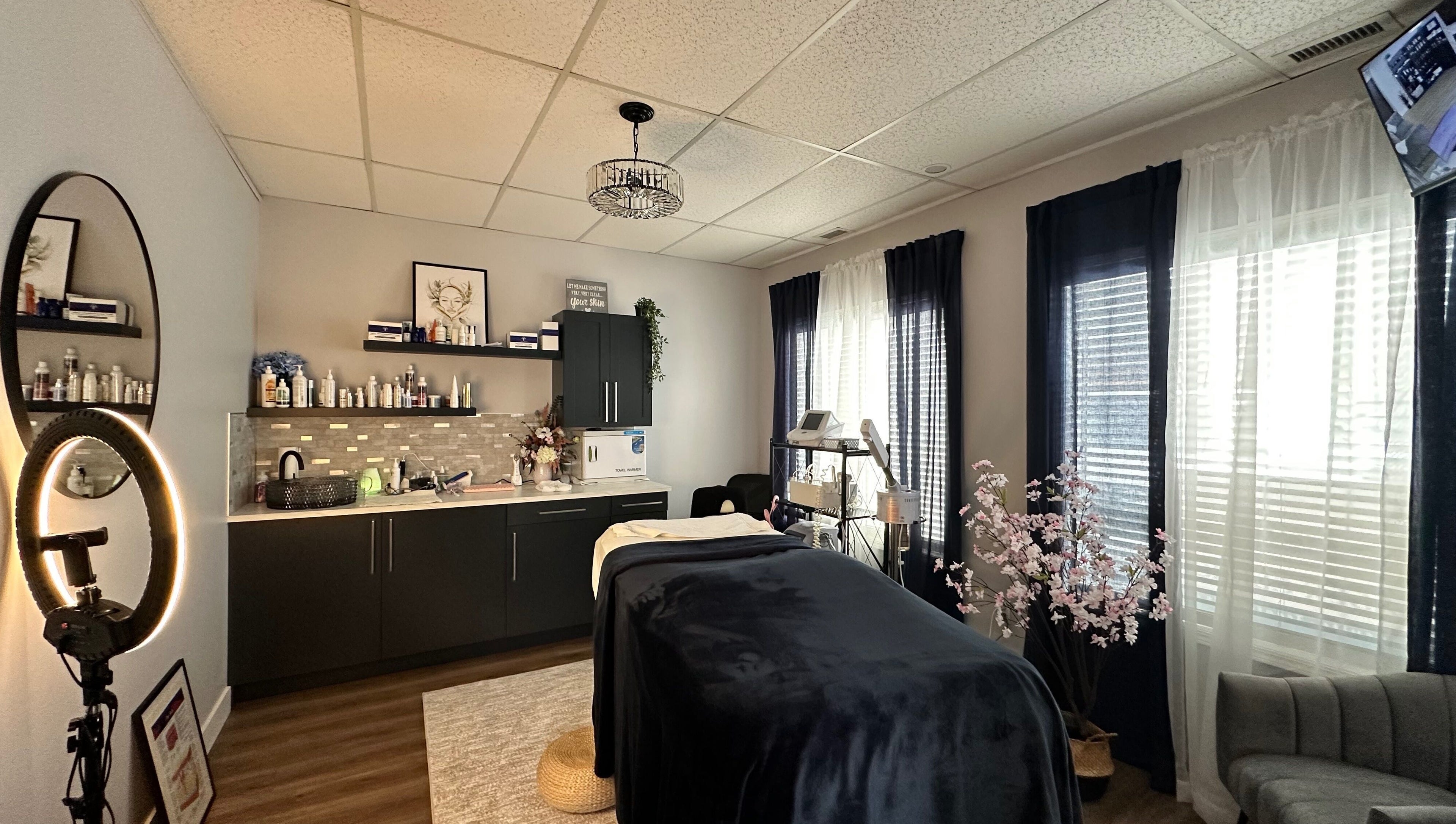 Relaxing treatment room at Radiate Skin Wellness in Whitecourt, Alberta, CA with elegant decor and spa bed.