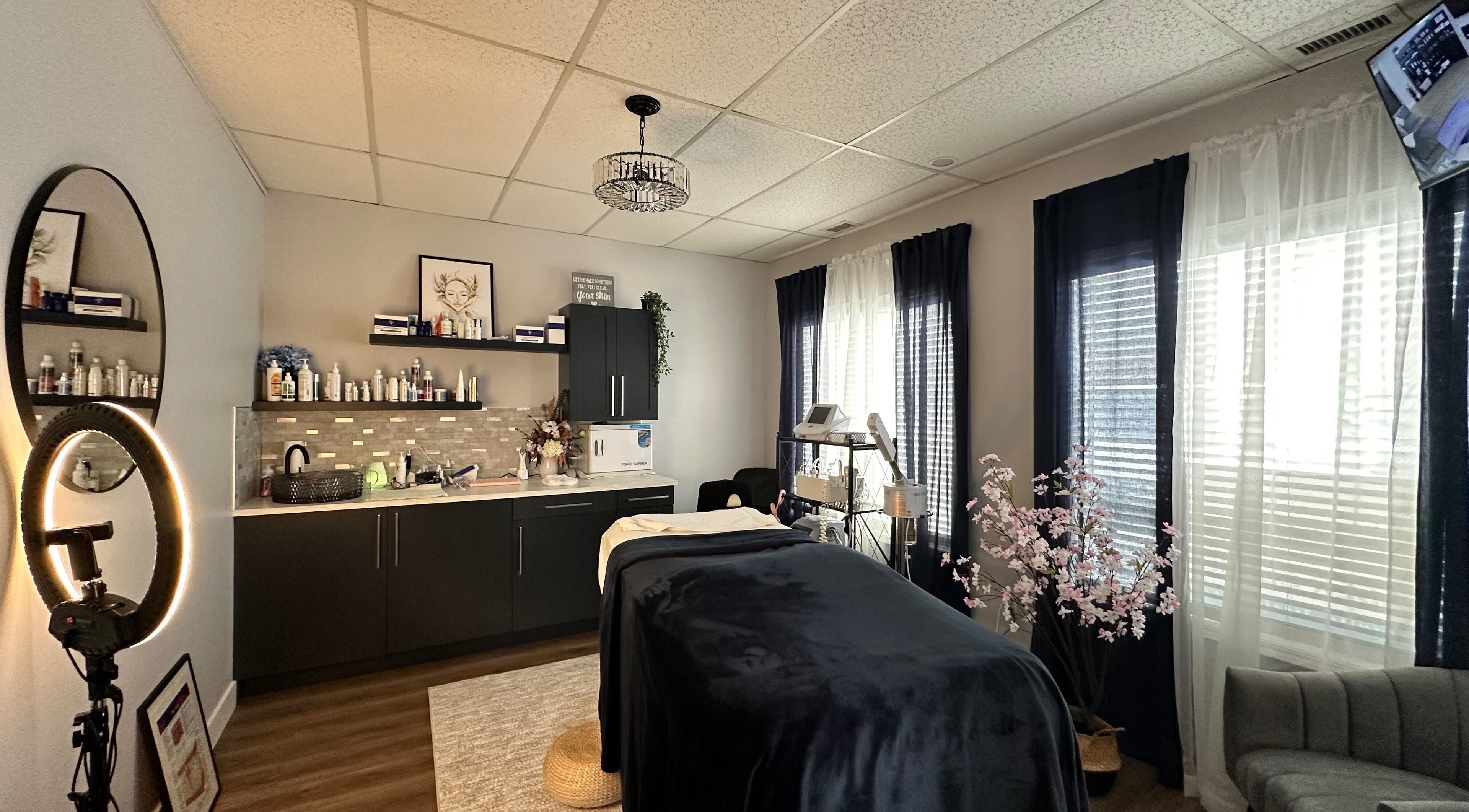 Relaxing treatment room at Radiate Skin Wellness in Whitecourt, Alberta, CA with elegant decor and spa bed.