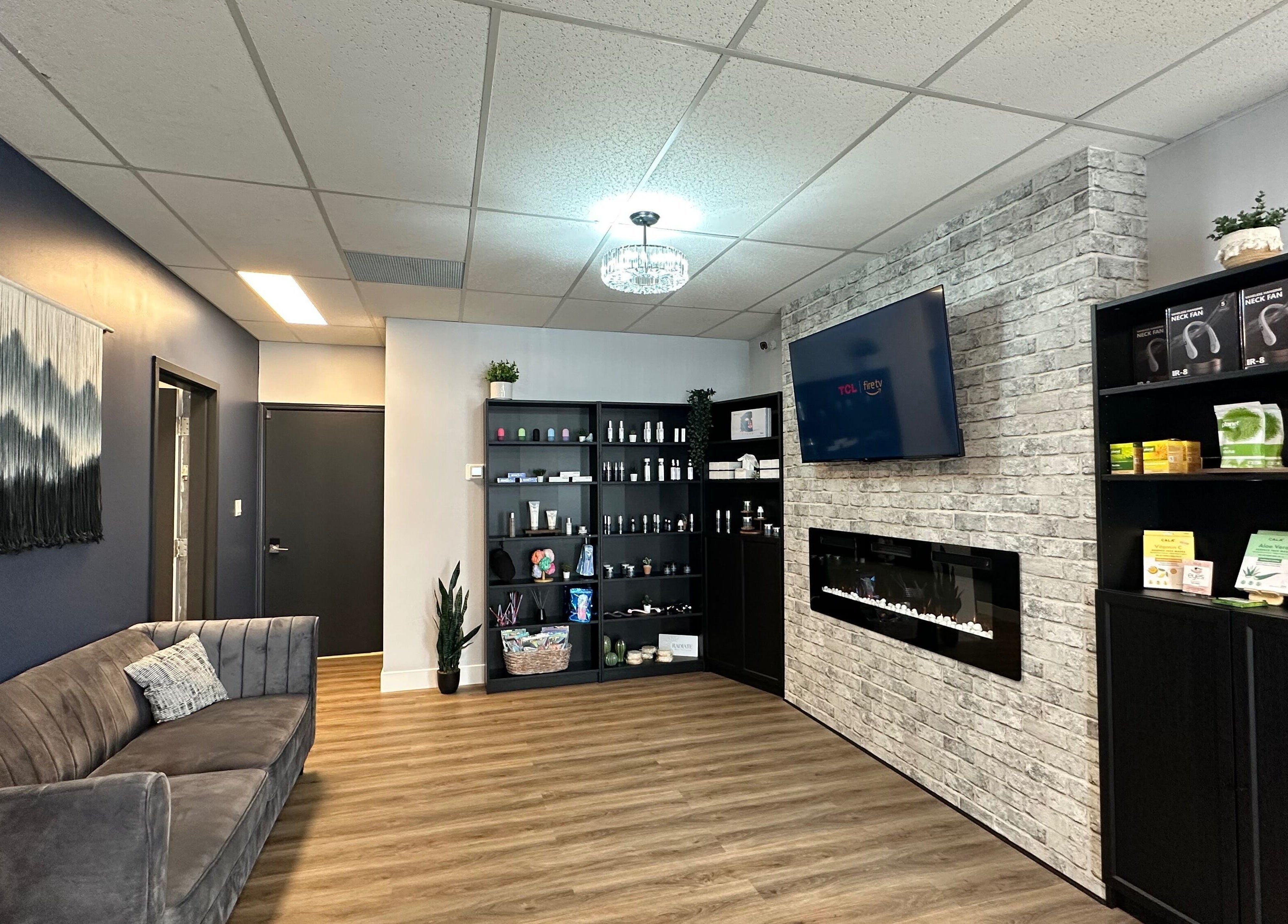 Cozy lounge area at Radiate Skin Wellness in Whitecourt, Alberta, CA with plush seating and wellness products.