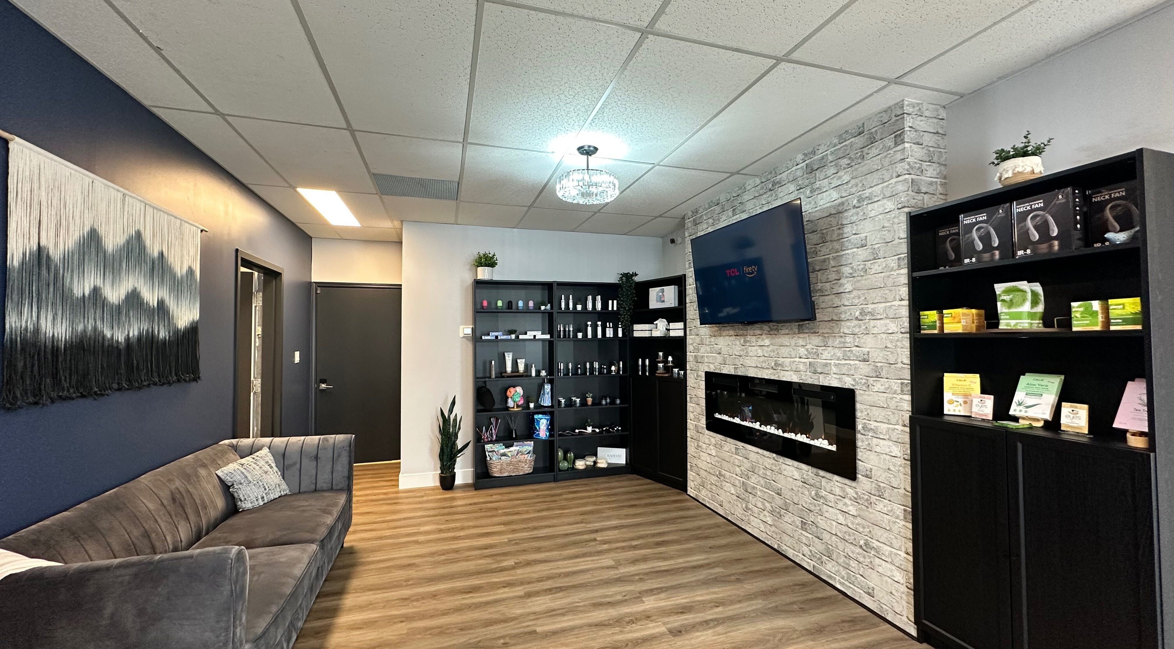 Cozy lounge area at Radiate Skin Wellness in Whitecourt, Alberta, CA with plush seating and wellness products.