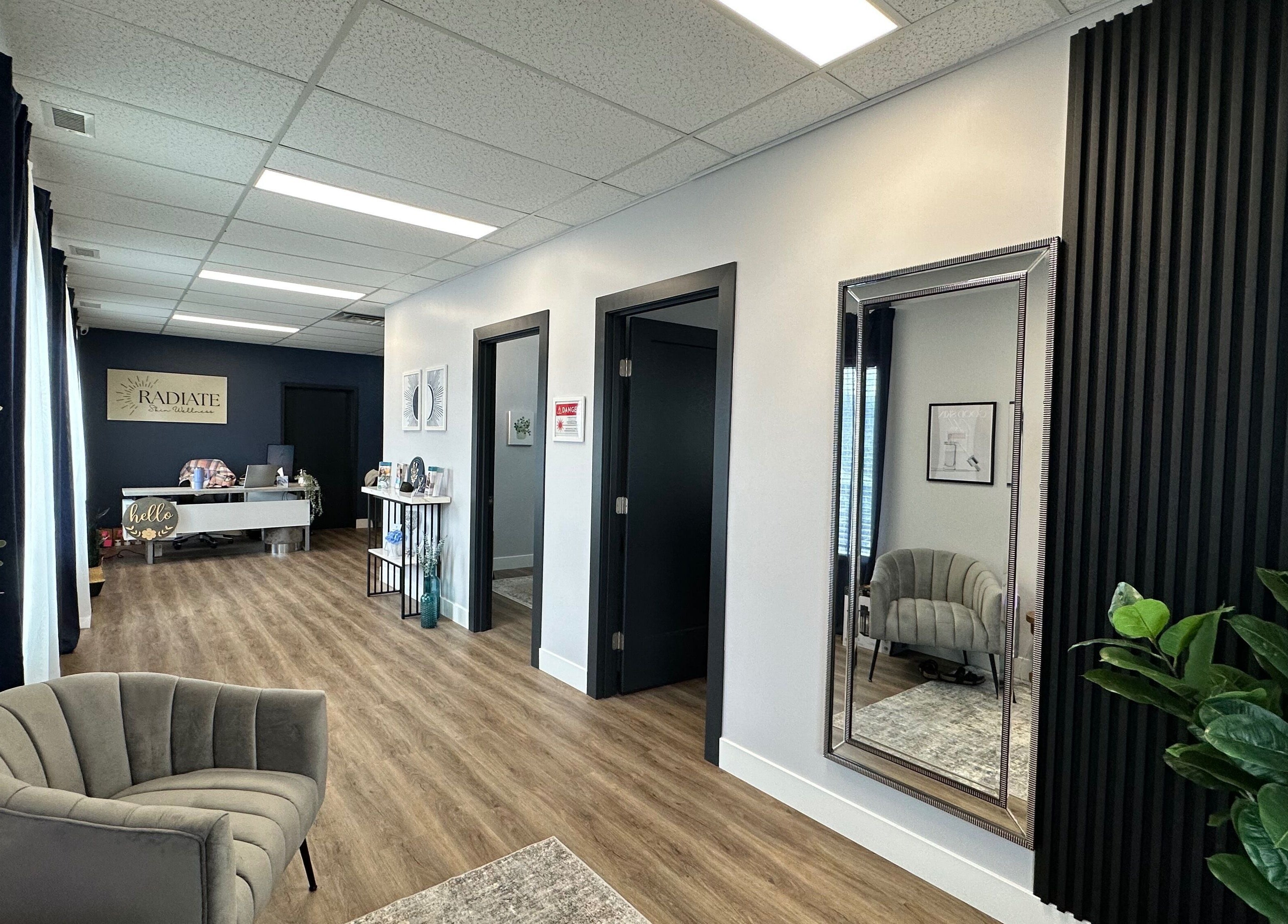 The welcoming lobby of Radiate Skin Wellness in Whitecourt, Alberta, CA, features stylish decor and seating.
