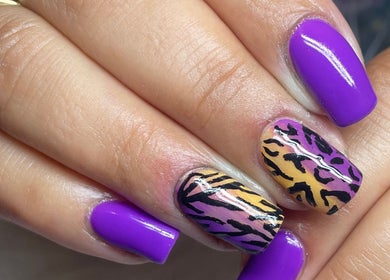 Vibrant nail art featuring purple polish and leopard design by Beauty by Eme - Mobile Nails & Beauty Birmingham.