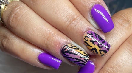Vibrant nail art featuring purple polish and leopard design by Beauty by Eme - Mobile Nails & Beauty Birmingham.
