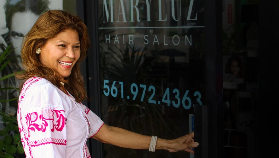 Smiling woman entering MaryLuz Hair Salon, Jupiter, Florida, US.