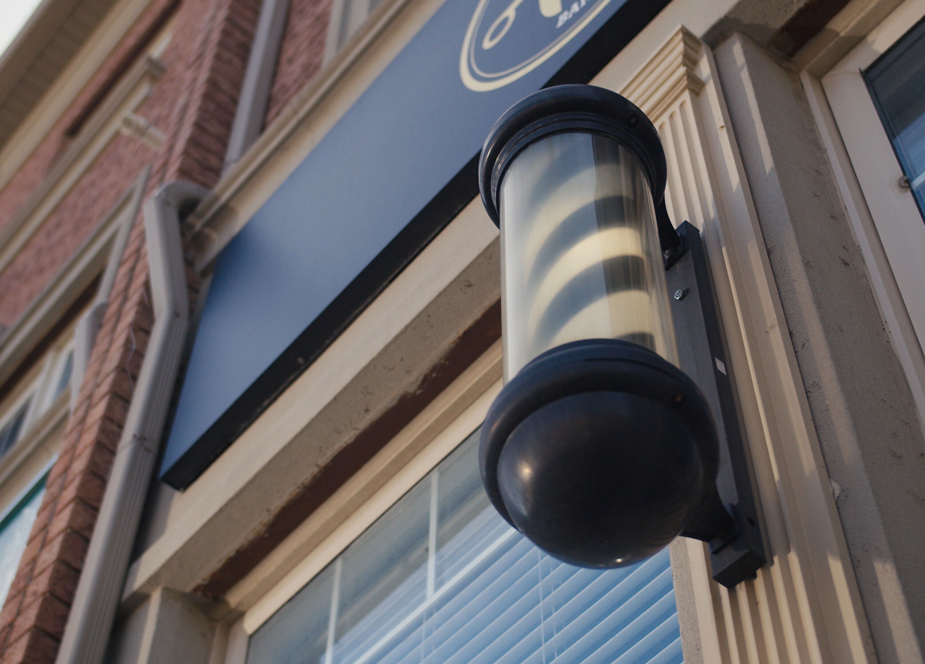 Exterior light at One Touch Barbers Inc, Markham, Ontario, CA emphasizing the sleek building design.