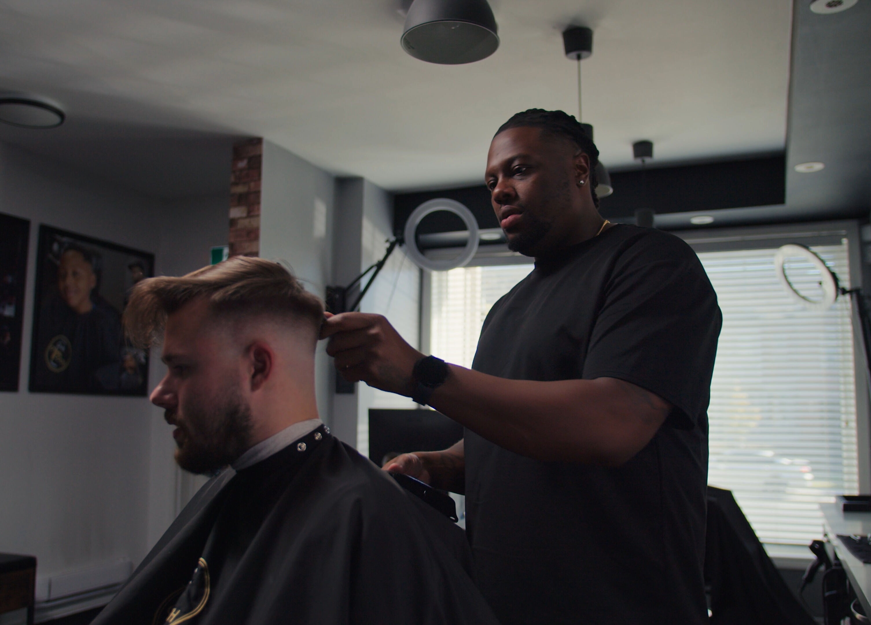 Barber at One Touch Barbers Inc in Markham, Ontario, CA styling a client's hair with precision.