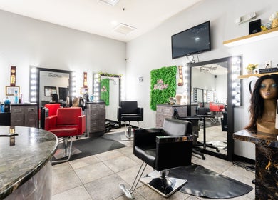 Interior of Hair in Motion of New York - MetroWest in Orlando, Florida, US featuring stylish salon chairs and decor.