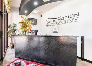 Chic reception at Hair in Motion of New York - MetroWest in Orlando, Florida, US, with elegant decor and signage.