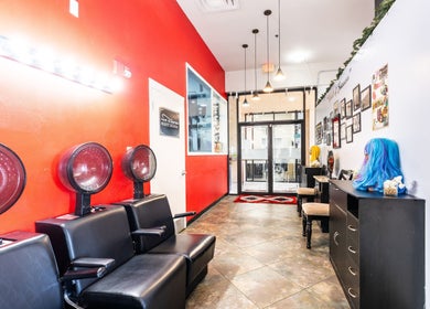 Hair in Motion of New York - MetroWest in Orlando, Florida, features vibrant salon chairs and decor.