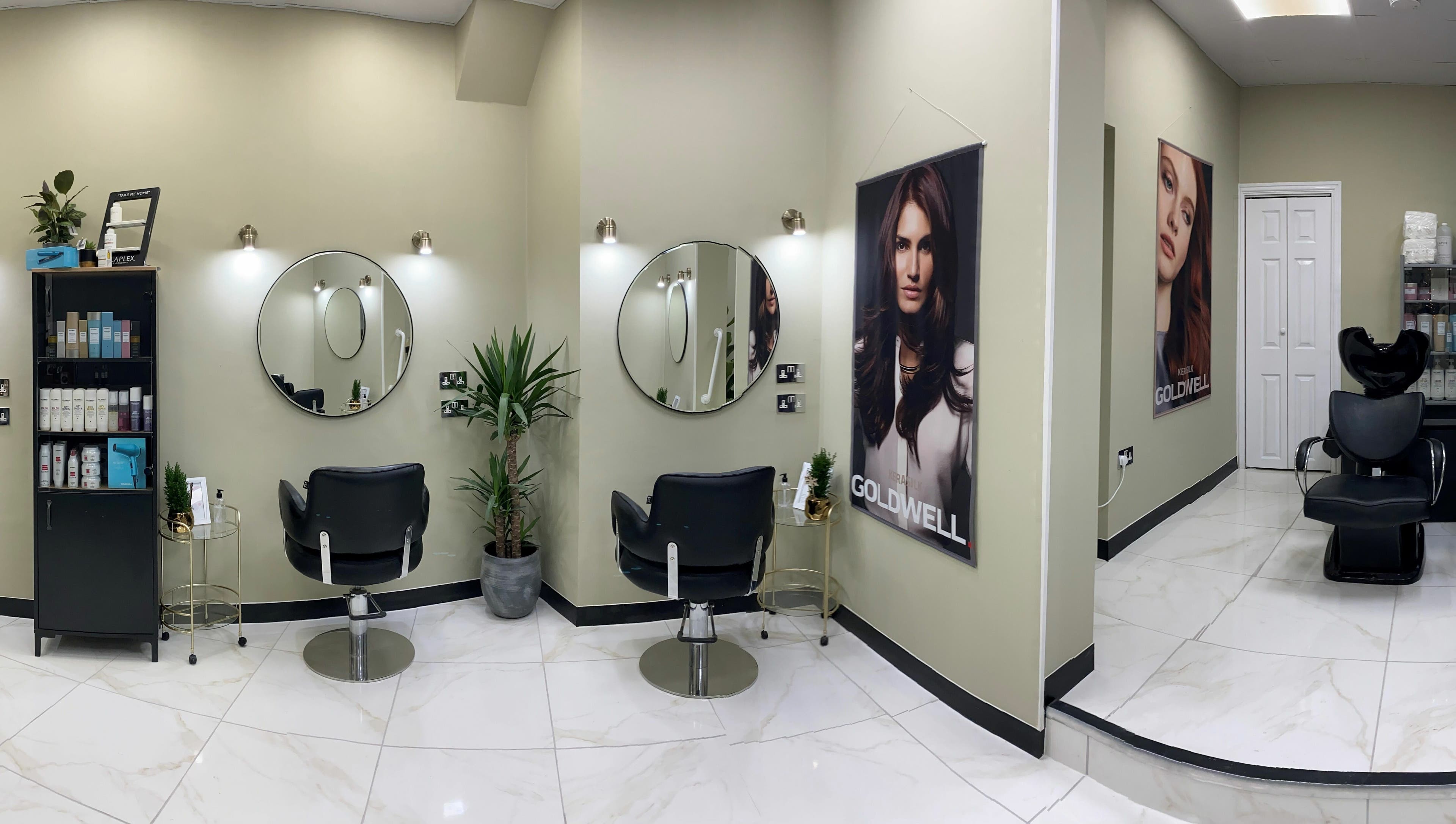 Elegant salon interior at Shear Desire, Shepshed, England, GB featuring modern decor and styling chairs.