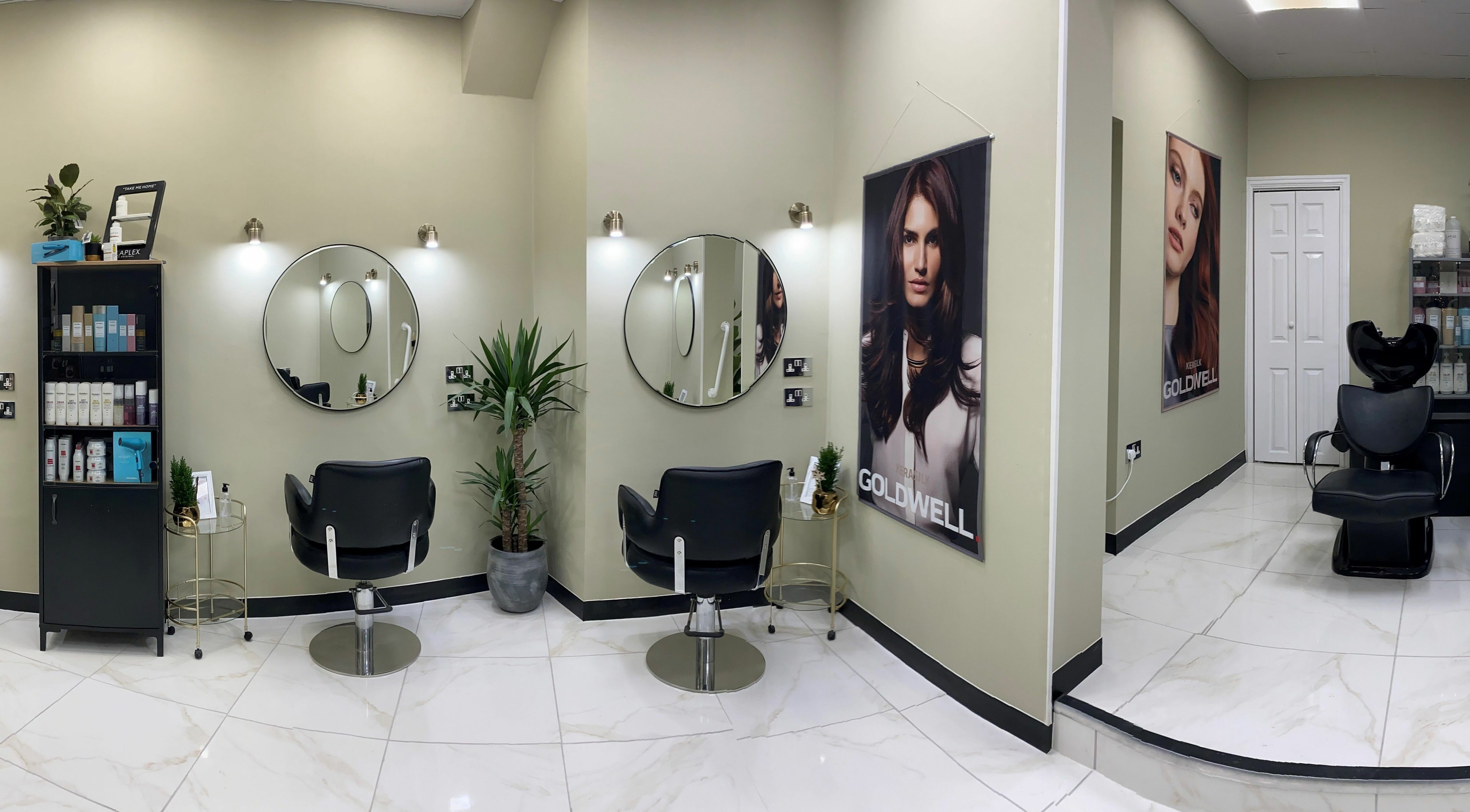 Elegant salon interior at Shear Desire, Shepshed, England, GB featuring modern decor and styling chairs.