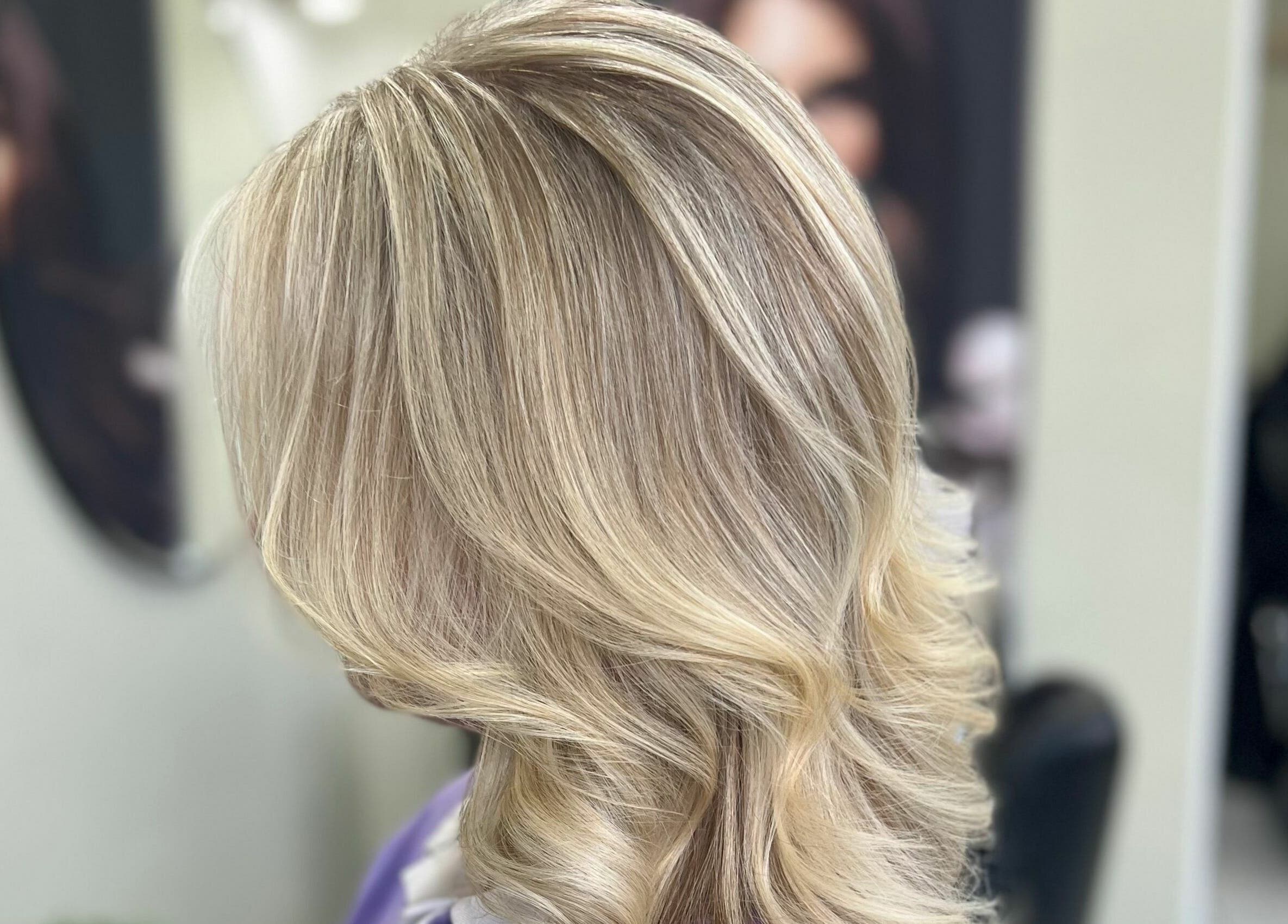 Wavy blonde hairstyle at Shear Desire, Shepshed, England, GB salon.