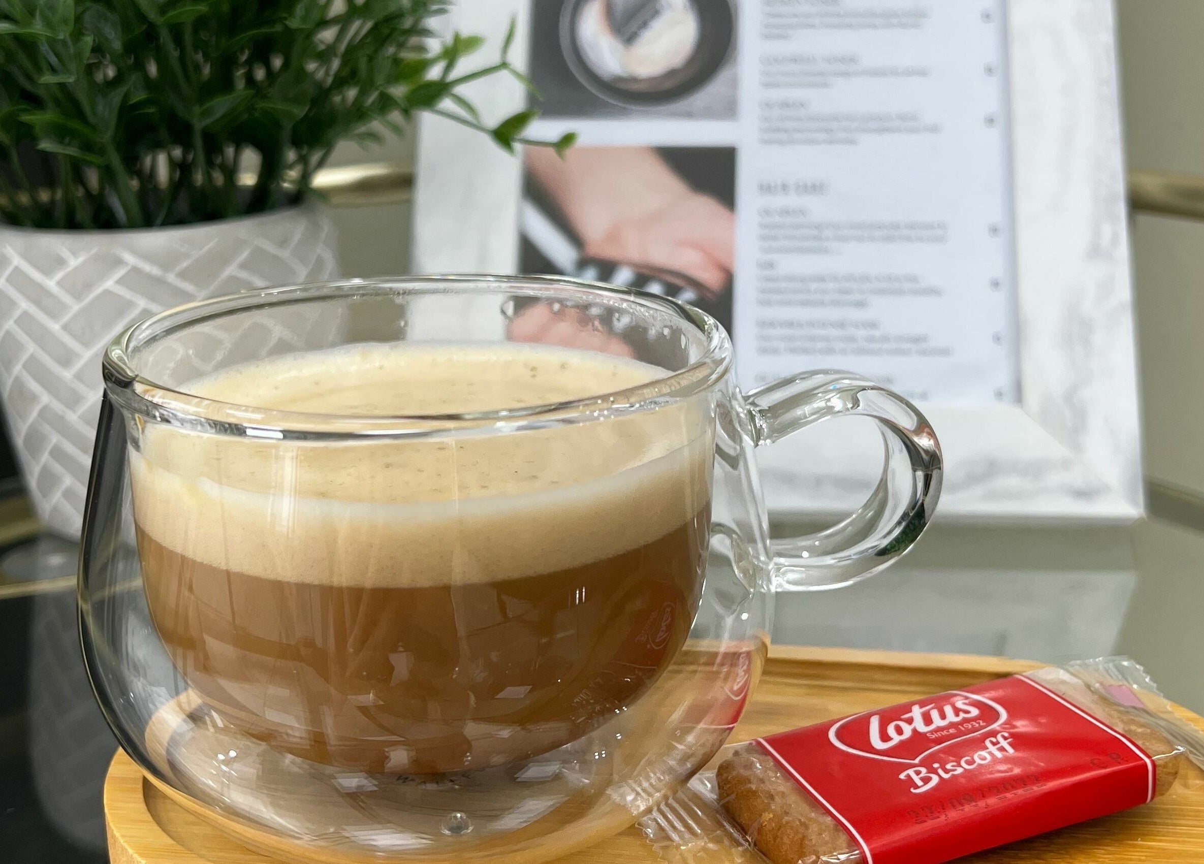 Cup of coffee and biscuit at Shear Desire, Shepshed, England, GB. A serene wellness experience.