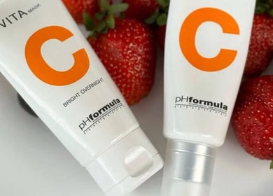 Vita C skincare products at Belle Ame Beauty in Bloemfontein, Free State, ZA alongside fresh strawberries.