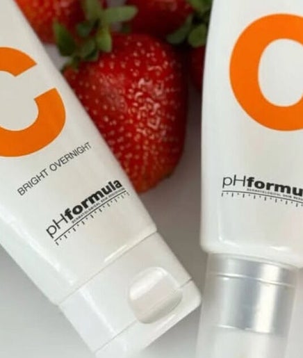 Vita C skincare products at Belle Ame Beauty in Bloemfontein, Free State, ZA alongside fresh strawberries.