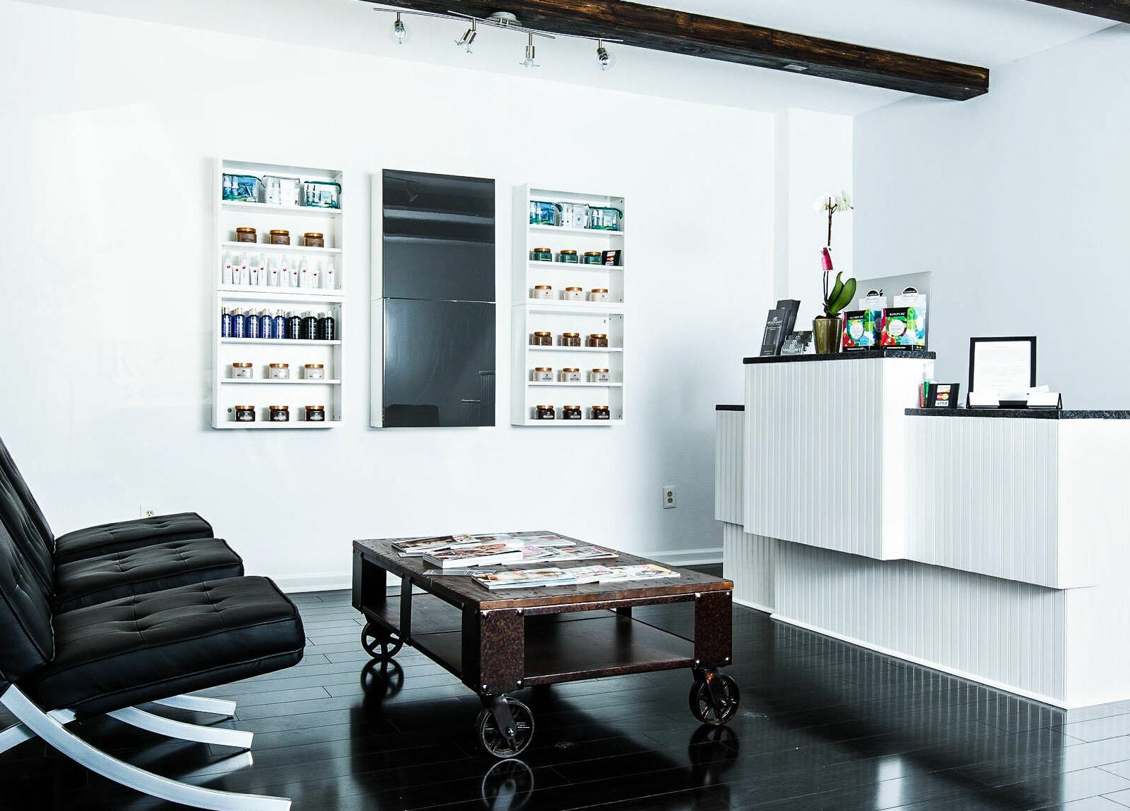 Modern reception area at Braziliant Body Waxing in Ridgefield, Connecticut, US with sleek furniture and product displays.