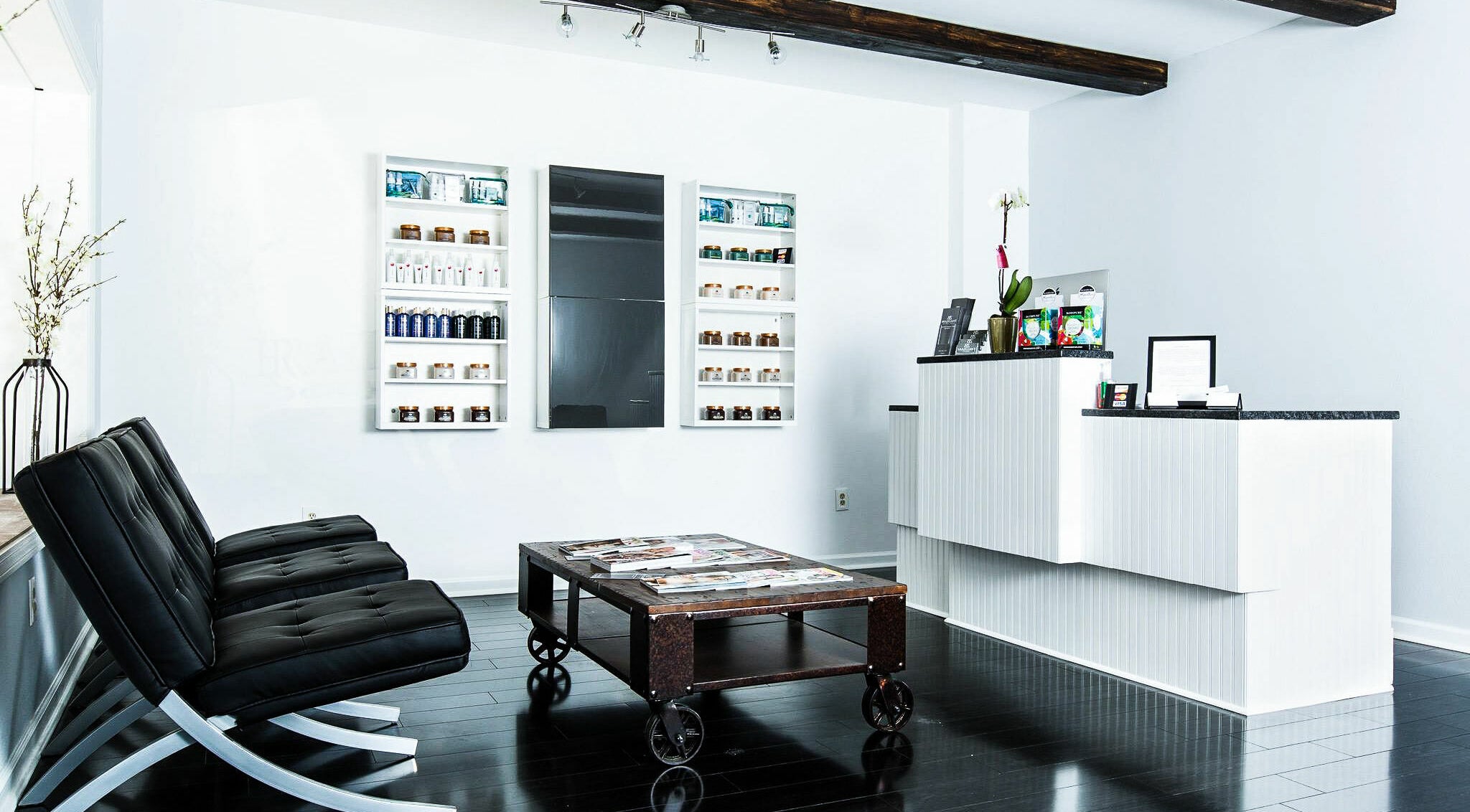 Modern reception area at Braziliant Body Waxing in Ridgefield, Connecticut, US with sleek furniture and product displays.
