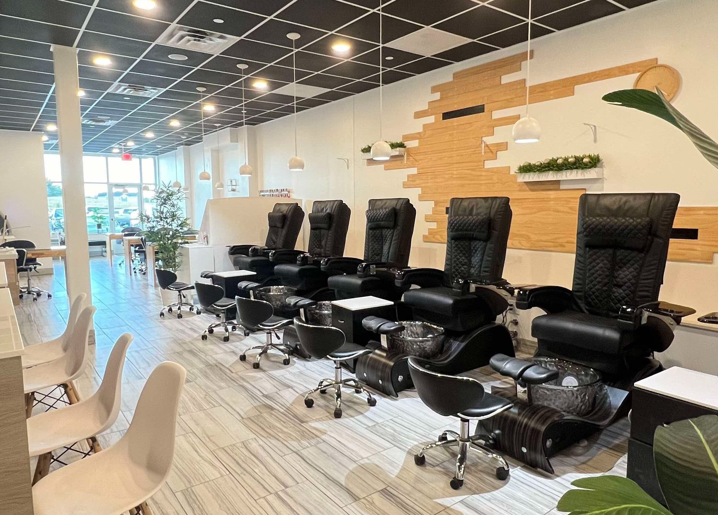 Modern pedicure stations at ANGELISH NAIL SALON in Lake Elmo, Minnesota, US, featuring luxurious black chairs.