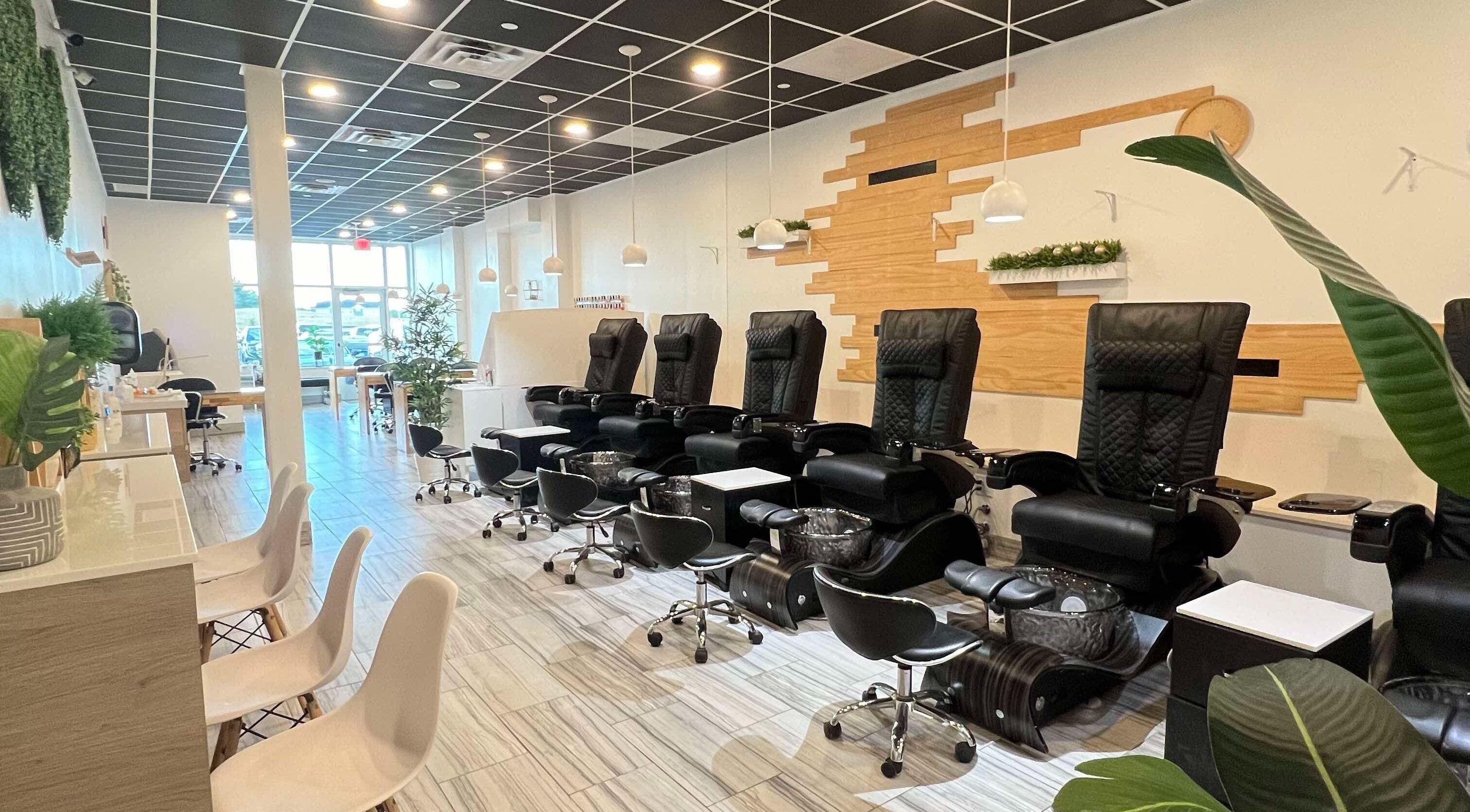 Modern pedicure stations at ANGELISH NAIL SALON in Lake Elmo, Minnesota, US, featuring luxurious black chairs.