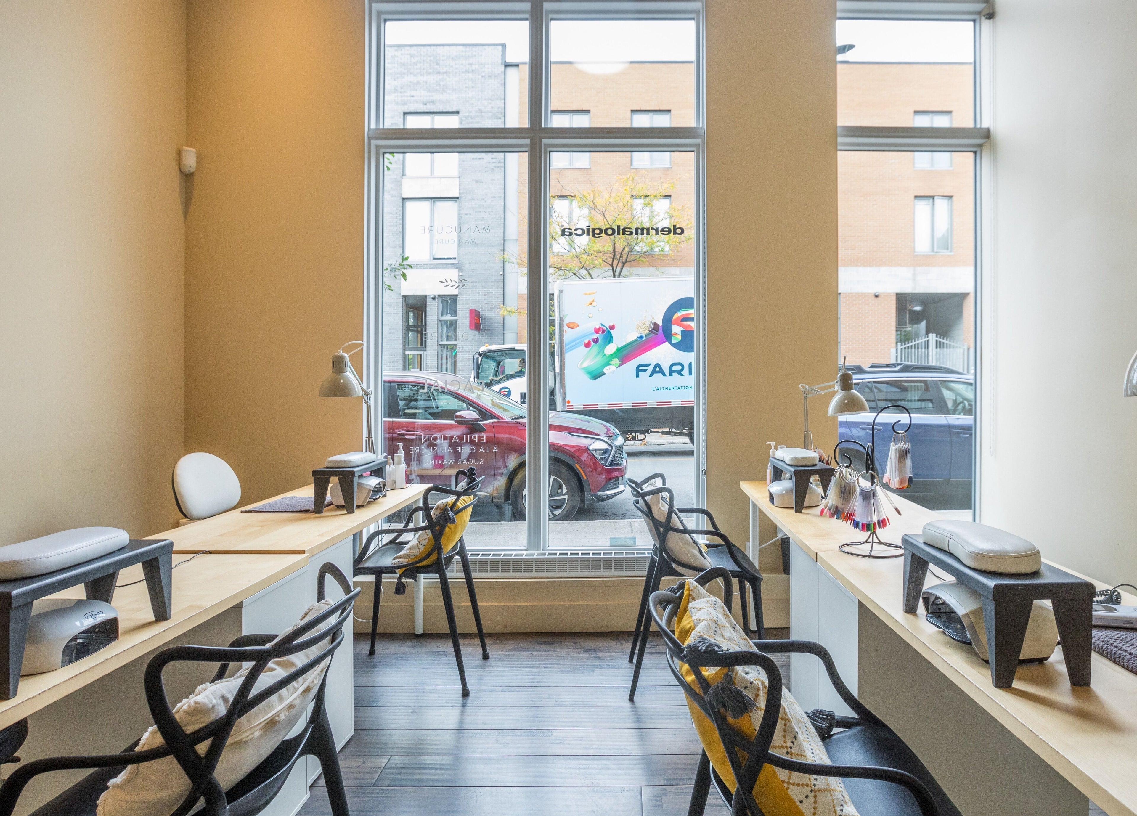 Modern nail service area at V and O Salon, Montréal, Québec, CA with stylish decor and large windows.