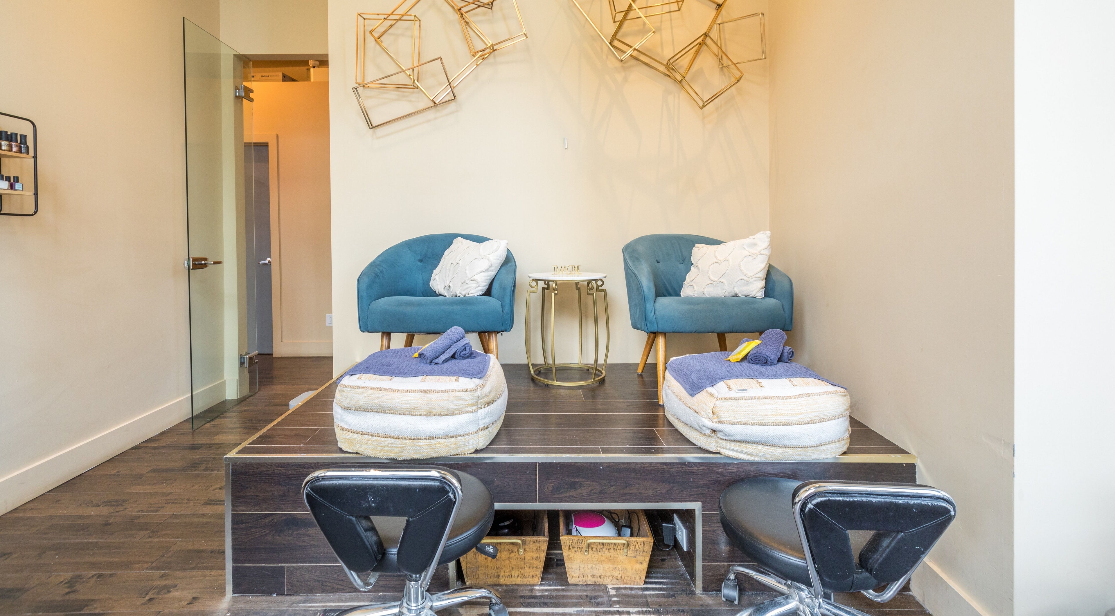 Luxurious pedicure area at V and O Salon, Montréal, Québec, CA with plush teal chairs and elegant decor.