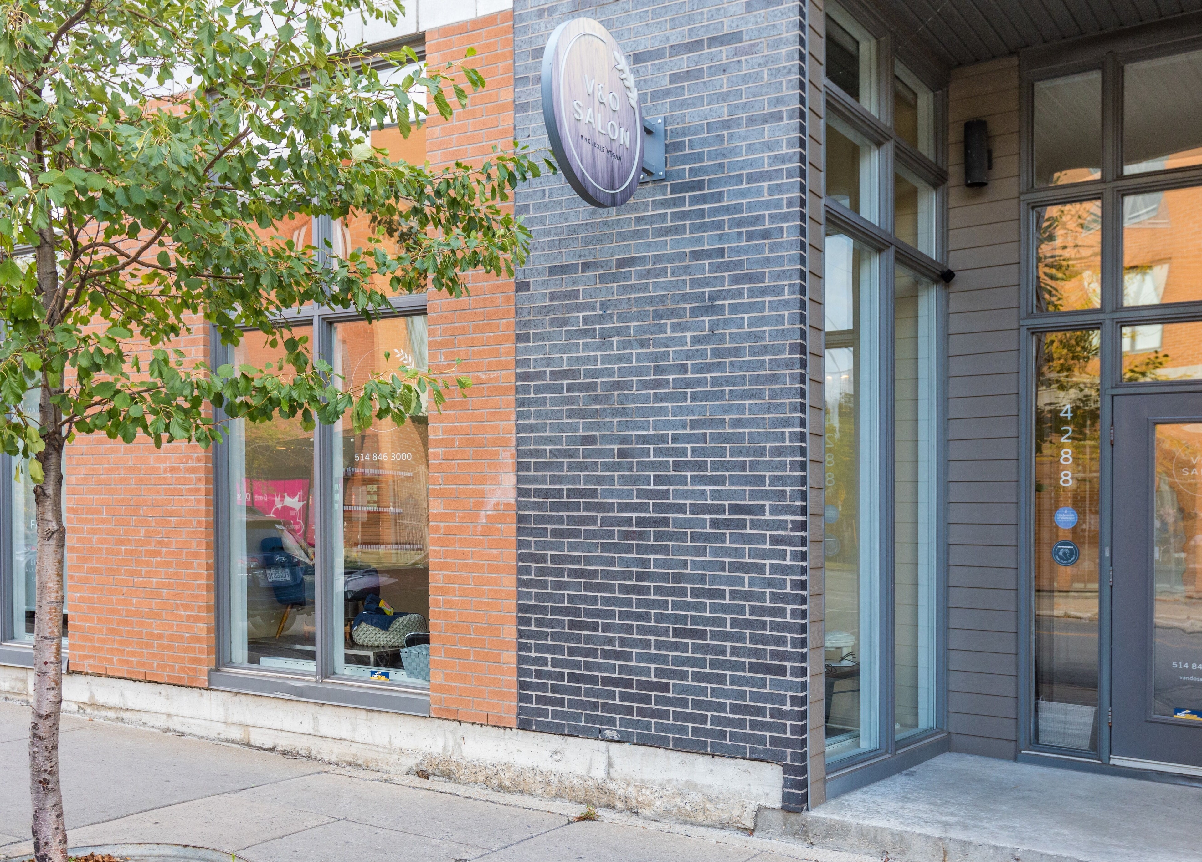 V and O Salon's modern facade in Montréal, Québec, CA, showcases elegant brickwork and large windows.