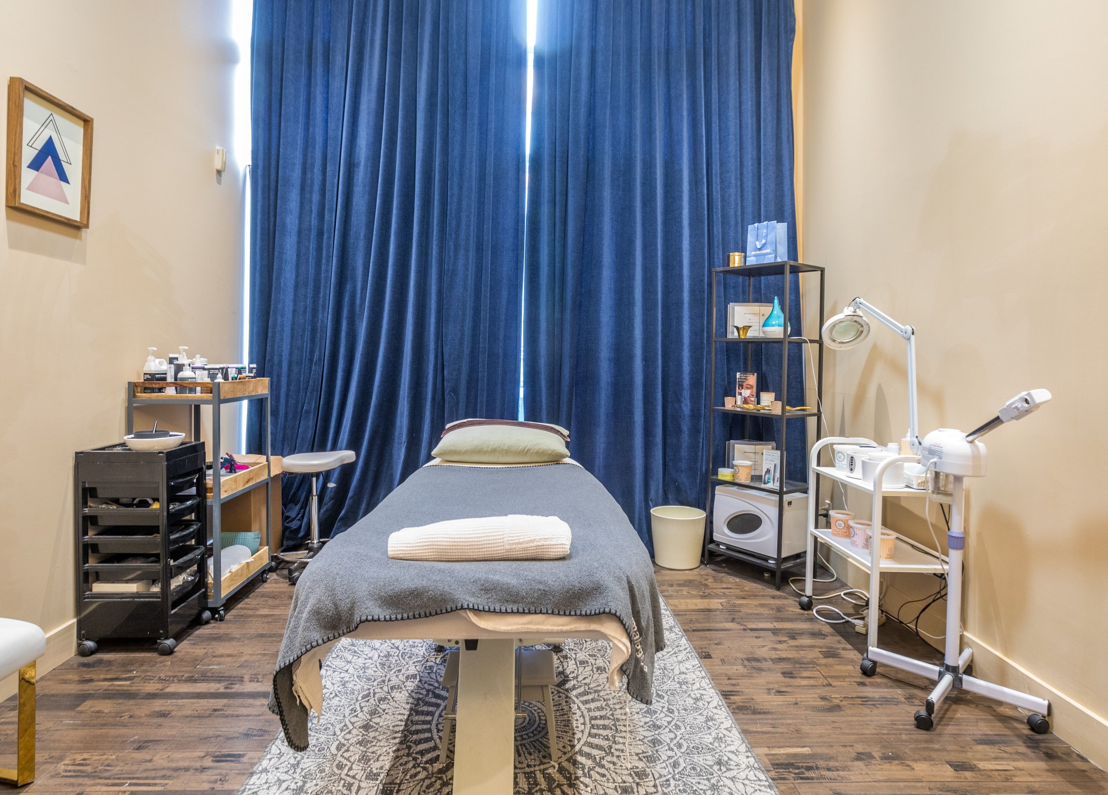 Tranquil spa room at V and O Salon, Montréal, Québec, CA, featuring a massage table and elegant decor.