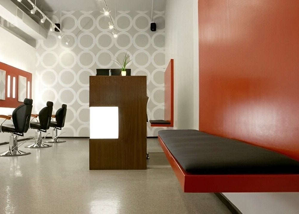 Chic interior of Thread - Financial District, New York, New York, US with sleek black chairs and red accents.